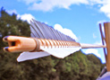 Medieval arrow with white and grey fletchings bound to the wooden shaft